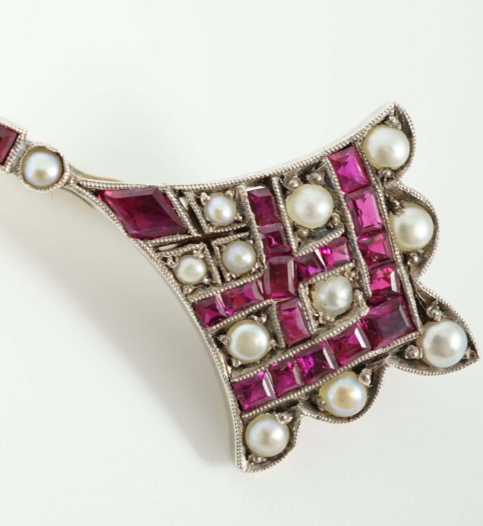 An early 20th century, gold, platinum, ruby and seed pearl set brooch